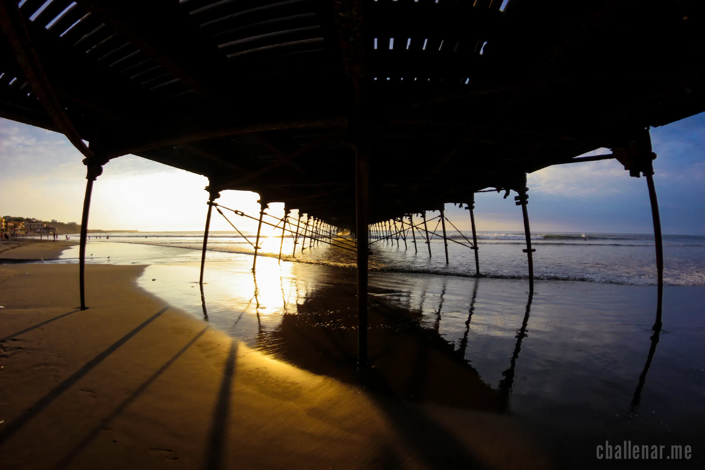 Photograph title 'Cold and Warm and All the Same' shows the under side of a dock which divides the landscape in a warm sunny side on the left and a cool blue sky on the left.
